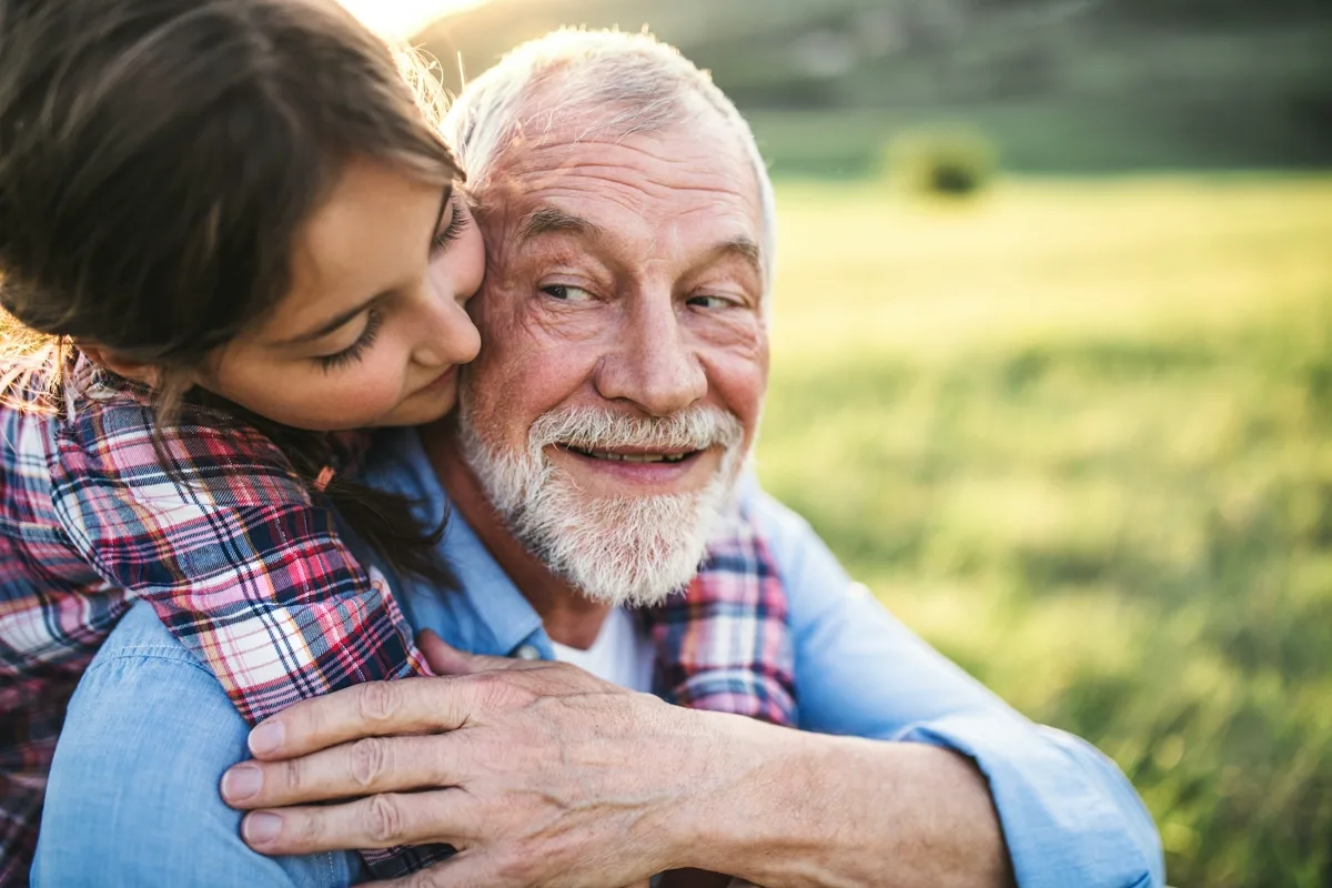 Family member hugging elderly person with dementia